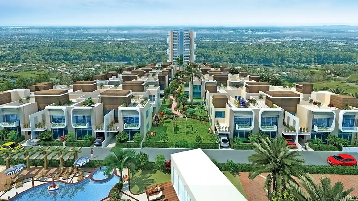 NCR Auriel Towne Villa — Aerial render of a residential project with modern villas, green spaces, a central park, swimming pool, and a high-rise building in the background.