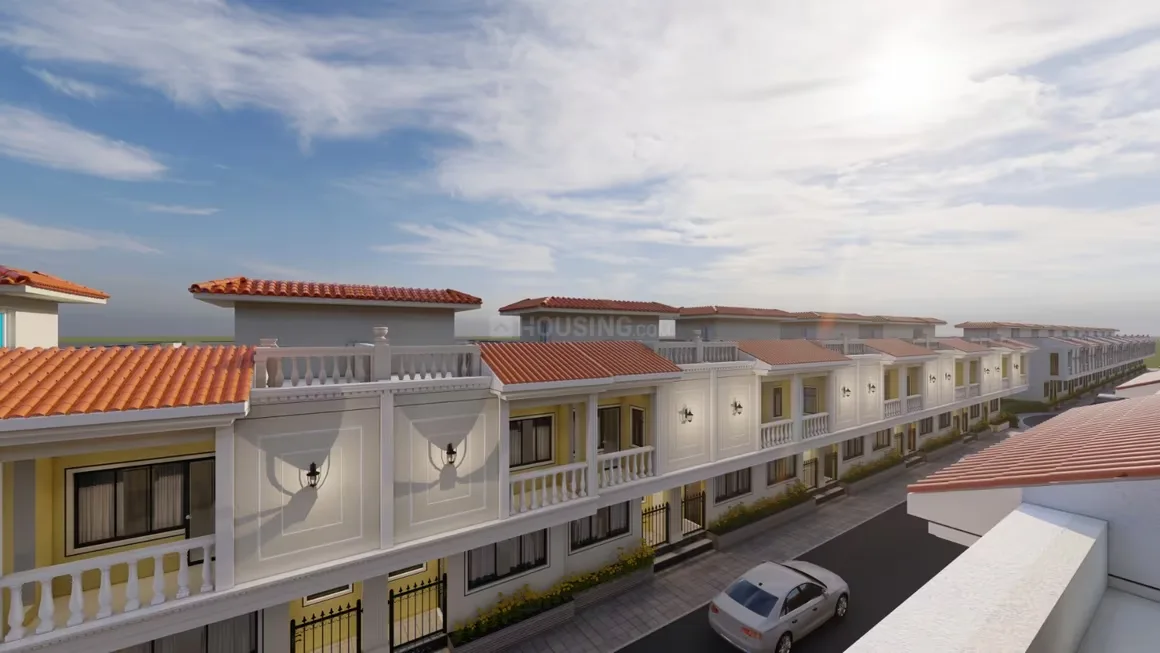 Trinity Primus — Top-down view of rendered row houses with white balconies and red tile roofs under a bright sky