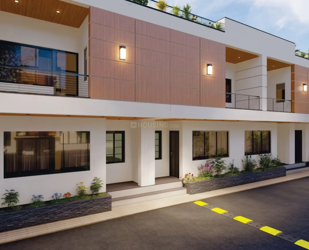 Aayansh Enclave — A modern residential building with balconies, flat roofs, and a speed bump on the paved road in front.