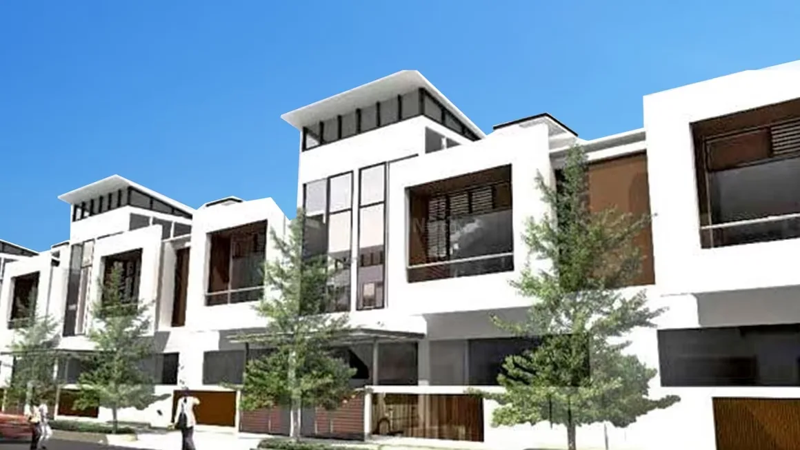 Ajnara Sports City Villas — Row of modern white villas with large windows and small trees in front, under a clear blue sky