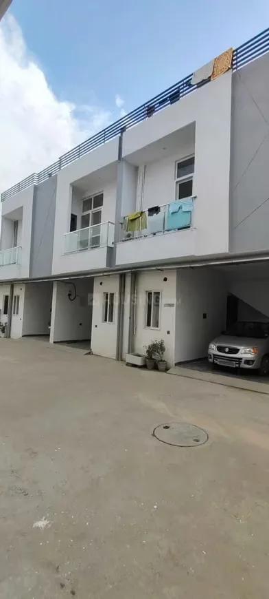 SK Sunshine Villa — Row of modern villa exteriors with balconies, car parking spaces, and clothes drying on railings